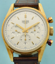 Load image into Gallery viewer, Heuer Chronograph, "Carrera, 1964 re-edition", No. 1119, Ref. CS3140 in yellow gold. Made in a numbered series circa 1996. Two-tone silver with applied yellow gold faceted baton indexes and luminous dots, outer minutes and 1/5th seconds track, inner scale for conversion of time into 100 fractions per minute, subsidiary dials for the seconds, the 30-minute and 12-hour registers. Luminous yellow gold baton hands.