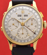 Load image into Gallery viewer, Minerva, triple calendar chronograph, made circa 1955. Dial: Brushed silver with applied Roman numeral at 12 and gold markers, outer minutes and 1/5th seconds track, subsidiary dials for the seconds, the 12-hour and 30-minute registers, apertures for the days of the week and months in French. Thin hands. Signed Minerva.
