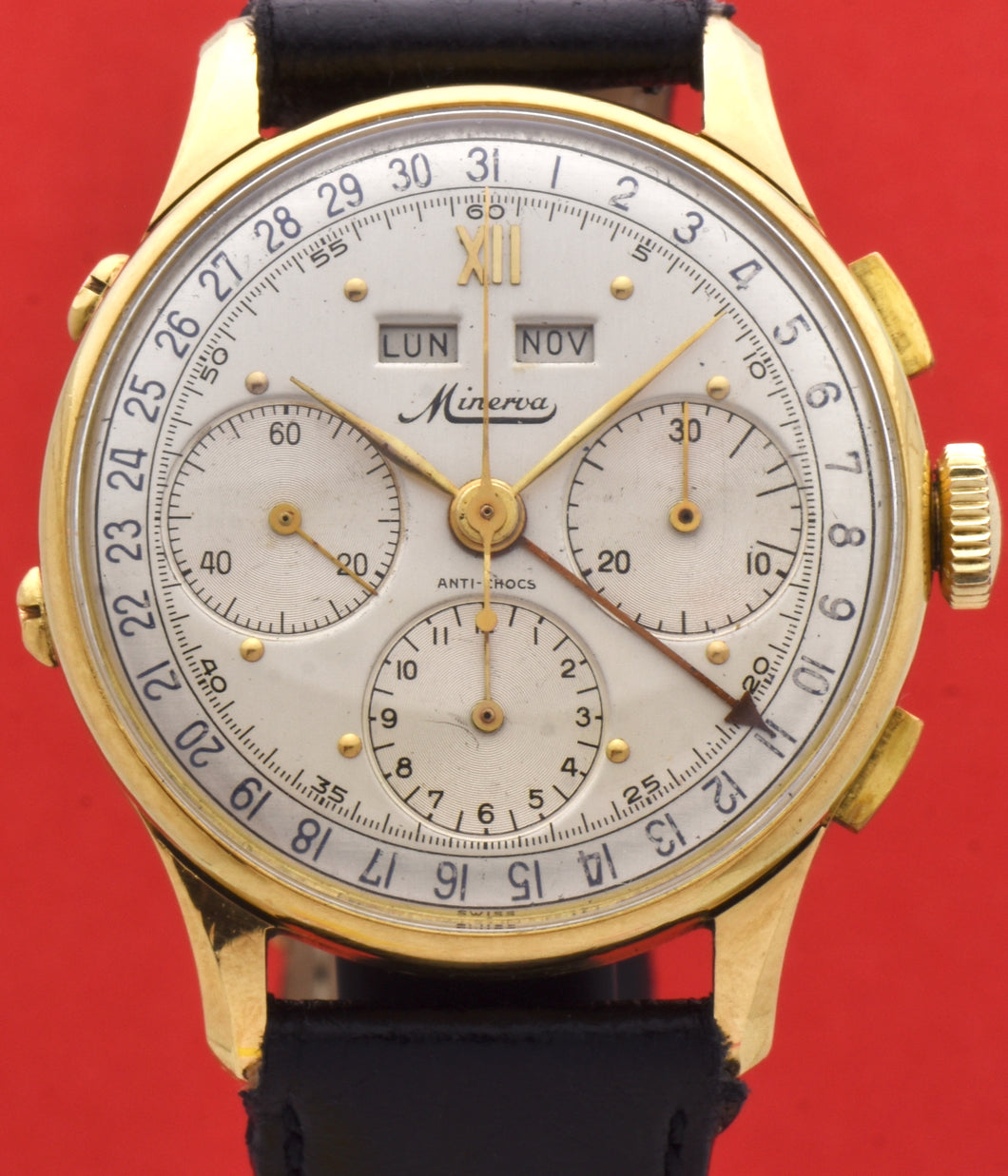Minerva, triple calendar chronograph, made circa 1955. Dial: Brushed silver with applied Roman numeral at 12 and gold markers, outer minutes and 1/5th seconds track, subsidiary dials for the seconds, the 12-hour and 30-minute registers, apertures for the days of the week and months in French. Thin hands. Signed Minerva.